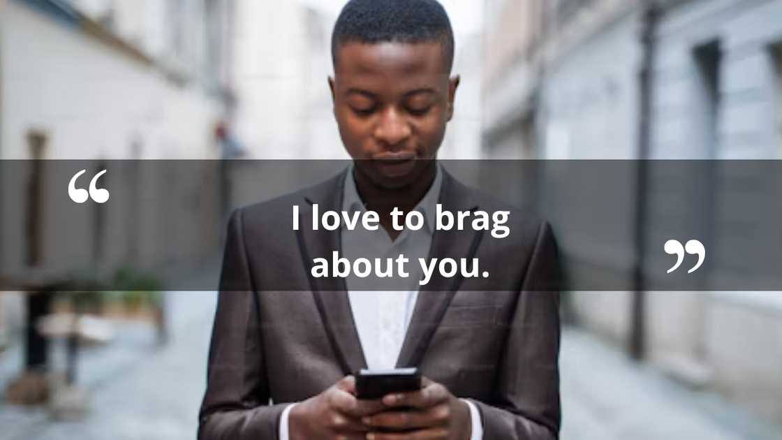 A guy smiles as he reads something on his phone A guy smiles as he reads something on his phone